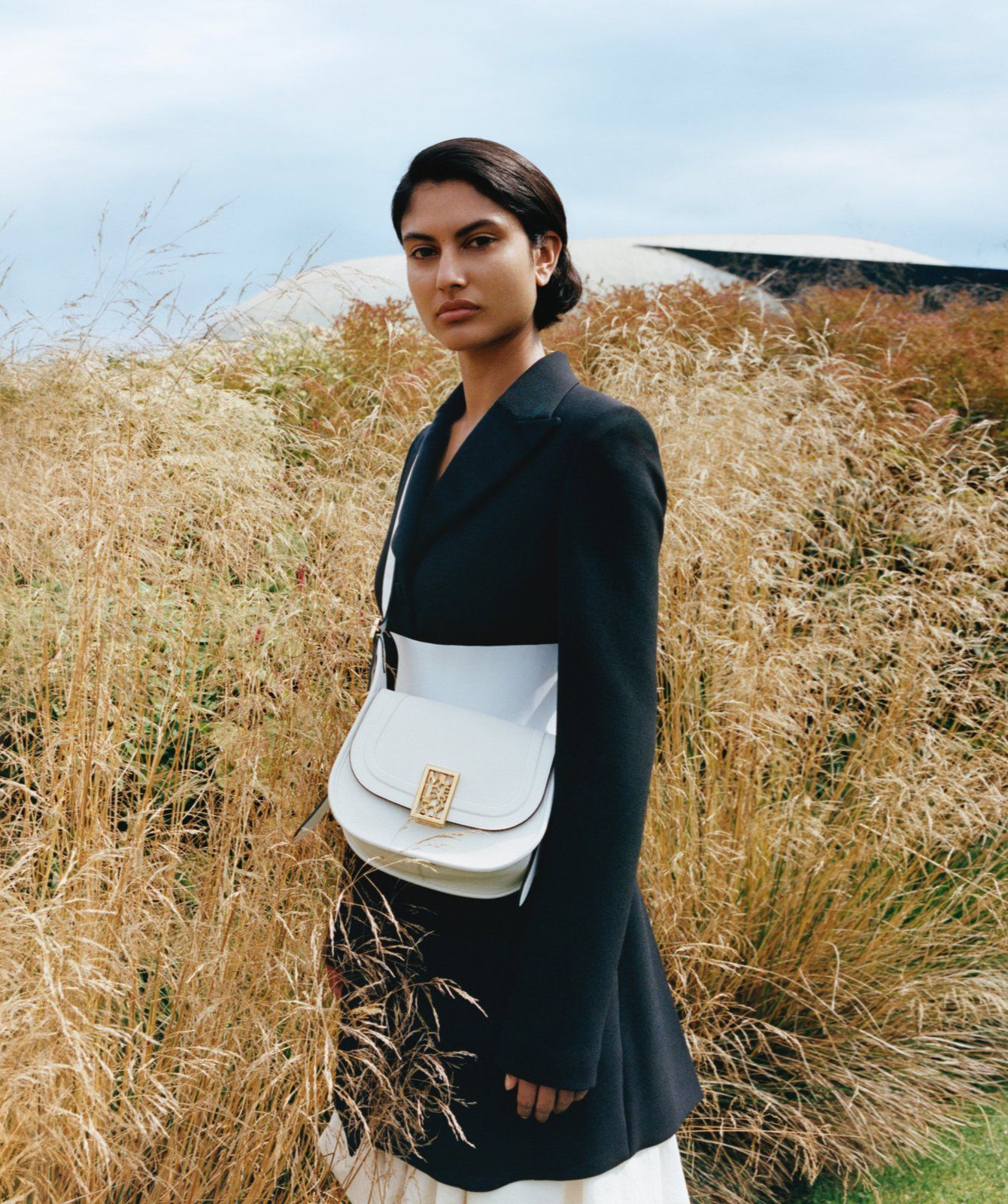 Model wearing Small Sadie Satchel in White High Shine Goat Print Leather